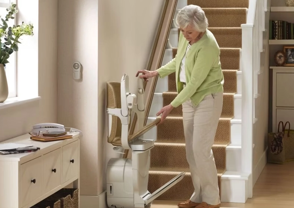 Women in Birmingham homing cleaning her stairlift to keep in top condition